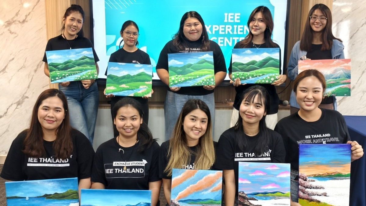 Year-end team building — company team holding their finished paintings after an Artime by Global Art workshop